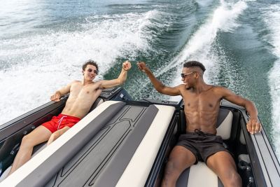  2 men sitting in the rear seats of a WTSurf wake boat