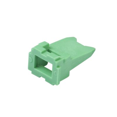 Green Deutsch W4P, DT 4-way receptacle wedge with a rectangular opening and grooved surface, designed for electrical connections.