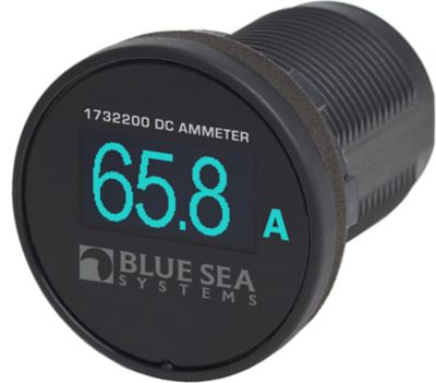 Close-up of Blue Sea Systems mini OLED ammeter displaying current reading on a sleek, round black panel.