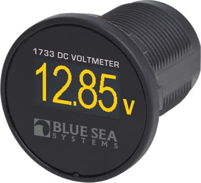 Black cylindrical voltmeter with bright yellow digital display from Blue Sea Systems, model 1733-BSS, showing voltage reading.