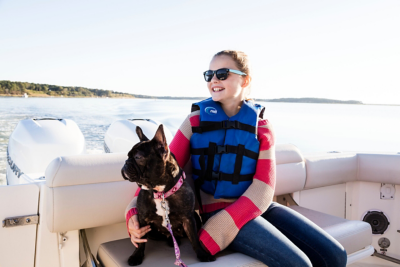 Girl Sitting with French Bulldog in Boston Whaler Outrage Center Console Boat