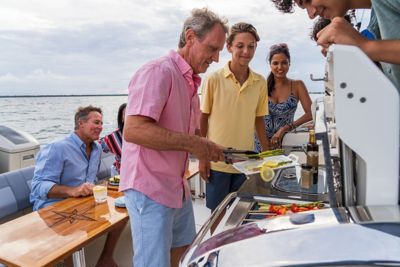 Family grilling on summer kitchen