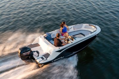 Man Driving Bayliner Element Bowrider Boat, Woman Sitting in Bow, Starboard View