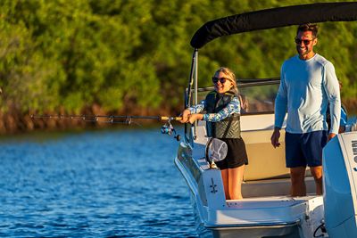 Boston Whaler side Console Fishing Boat Anchored with 2 Passengers Onboard 