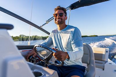 Man Driving Boston Whaler 210 Vantage Dual Console Boat