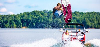 Wakeboarder up in the air behind the H20 wake boat