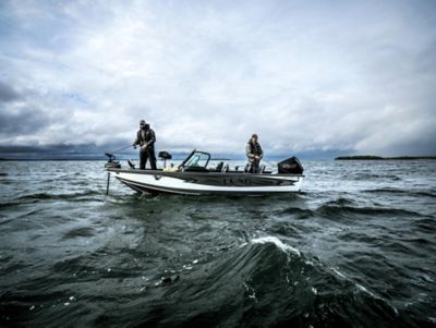 two men fishing on a Lund 1975 pro-v in stormy weather 