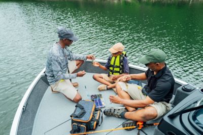 Man tying a knot on a Lowe fishing boat.