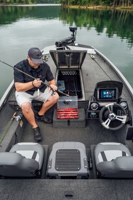 Angler removing a rod and reel from the bow storage of the Lowe Stinger 195 Bass to change the bait on his line. 