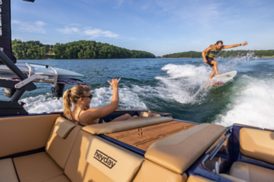 Woman Sitting in Heyday Wake Boat Watching Wake Surfer