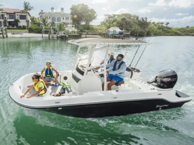 Man Driving Bayliner Trophy Fishing Boat, Father in Passenger Seat, Two Daughters Riding in Bow