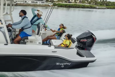 Man Standing on Bow at Bayliner Trophy Center Console Fishing Boat Reeling in Fish