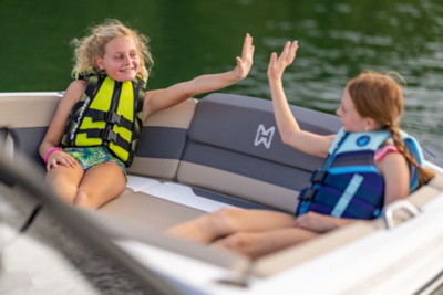 Two Girls Sitting in Heyday Wake Boat, High-Fiving
