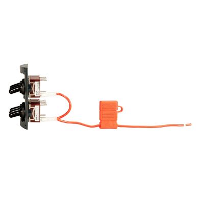Toggle switch panel with two black switches, connector plugs, and orange wire for electrical control systems.