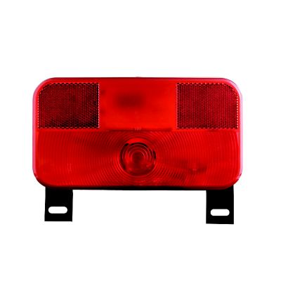 Red Optronics RV combination tail light for driver side with a black base and integrated license light.