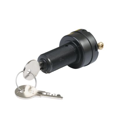 Marine ignition switch with keys attached, featuring a durable black design and three brass screws for secure installation.