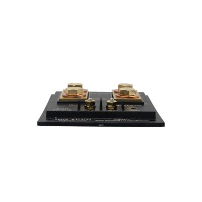 View from the side of a thin black solid state battery isolator switch with 4 lug connection points and mounting holes, 200 amp