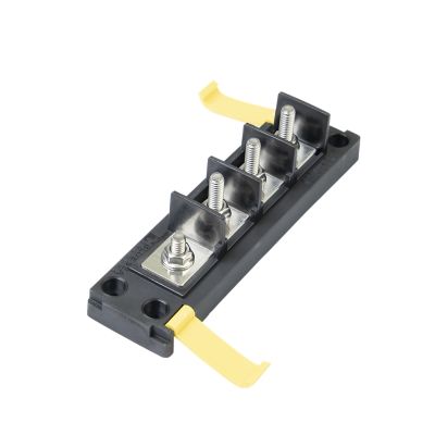Marine-rated battery fuse block for common source applications with yellow safety covers and robust metal terminals.