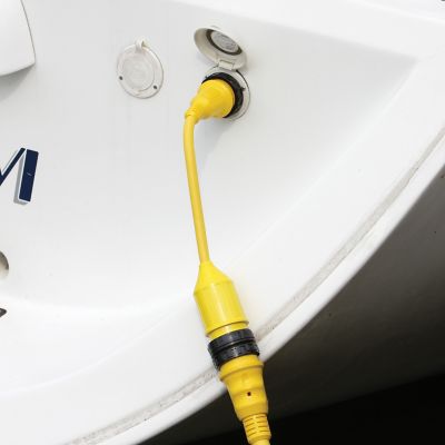Yellow Marinco Pigtail Adapter connected to a boat, illustrating its durable and weather-resistant design for marine use.