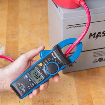 Ancor digital clamp meter in use, showcasing its functions and features during an electrical measurement task.