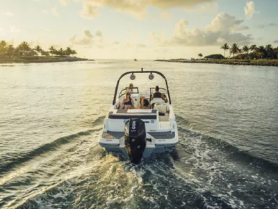 Four Women Riding on Bayliner Deck Boat, Stern View, Boat Underway