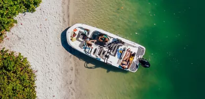 Four Women Riding on Bayliner Deck Boat, Stern View, Boat Underway