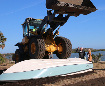 A forklift driving over a Boston Whaler model