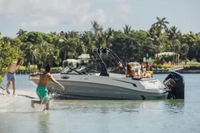 VR6 Outboard bowrider boat parked on a beach