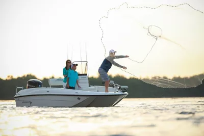 Two People in Bayliner Trophy Boat, casting net