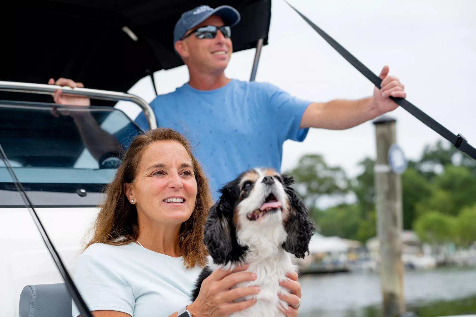 couple with dog on boat