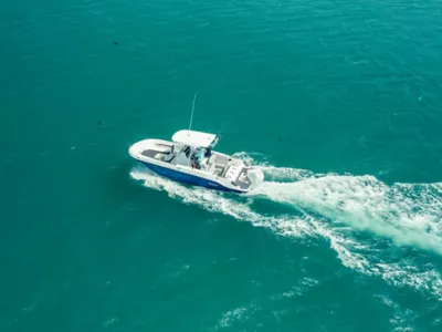 Couple Riding in Bayliner Trophy Center Console Fishing Boat, Starboard View, Boat Underway