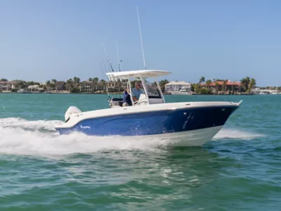 Couple Riding in Bayliner Trophy Center Console Fishing Boat, Portside View, Boat Underway