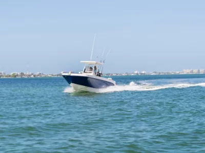 Couple Riding in Bayliner Trophy Center Console Fishing Boat, Port-Side Bow View, Boat Underway
