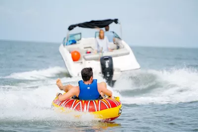 boat pulling someone in a tube