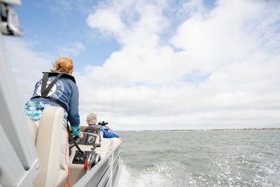 Woman Driving Pontoon Beach Backdrop