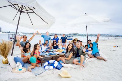 Family Eating Beach Picnic Freedom Staff