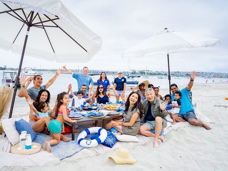 Family Eating Beach Picnic Freedom Staff