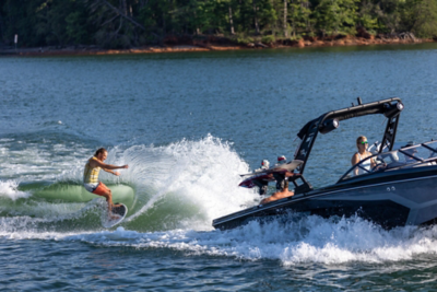 Woman Sitting in Heyday Wake Boat Watching Wake Surfer