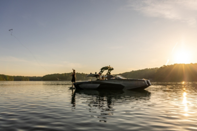 Two Girls Sitting in Heyday Wake Boat, High-Fiving