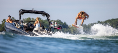 Wakeboarder Behind Heyday Wake Boat, Starboard View, Boat Underway