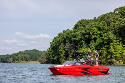  people standing on the back of a red H20 wake boat