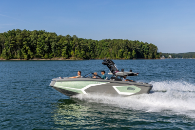 Green WT-2DC wake boat running at sunset