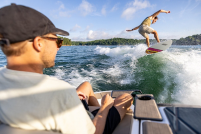 Two Girls Sitting in Heyday Wake Boat, High-Fiving