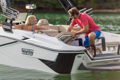  Man adjusting seat on the back of a H22 wake boat