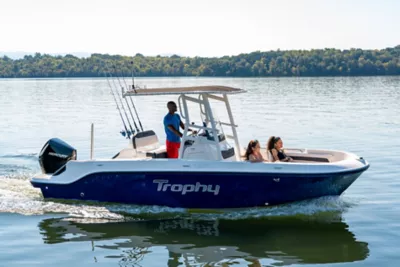 family riding a blue Trophy T22CC fishing boat