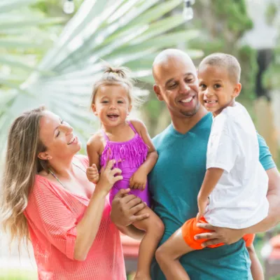 family smiling on a sunny day