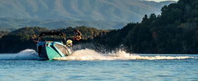 Wakeboarder up in the air behind the WTSurf wake boat