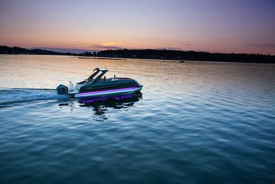 Harris Crowne 250 SL Tritoon Running at Sunset with Two Riders Aboard