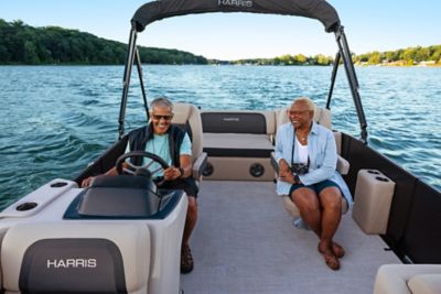 Couple enjoying a cruise aboard the Harris Cruiser 210.