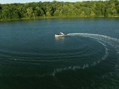 Grand Mariner Pontoon Boat running across the water.